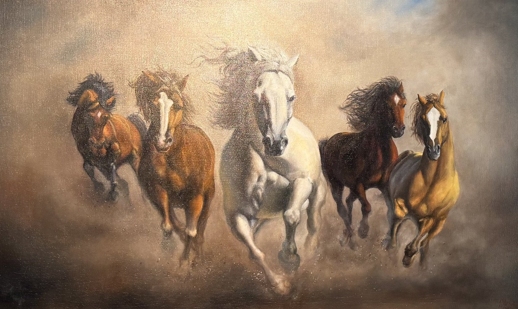 Five horses galloping side by side through golden dust